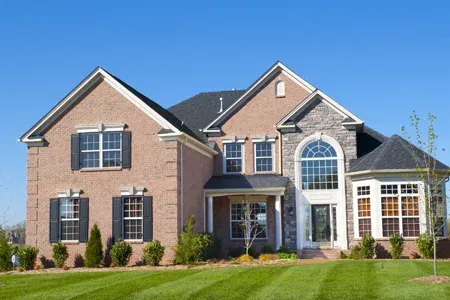 brick home with green front lawn