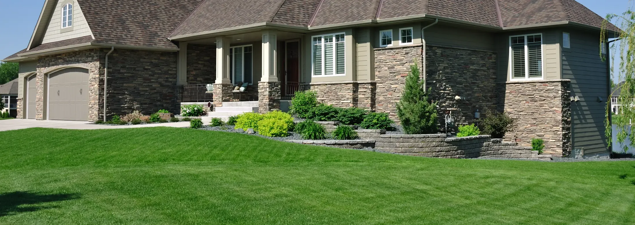 Brick home with green healthy grass